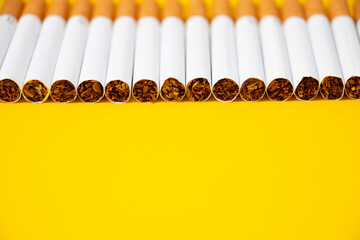 Line of cigarettes which made lung cancer and another diseases with filter and tobbaco separated on...