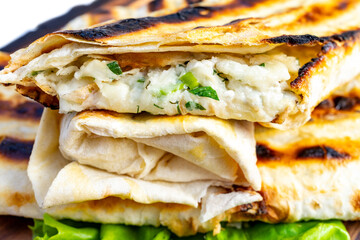 Grilled flatbread wraps filled with savory cheese and herbs