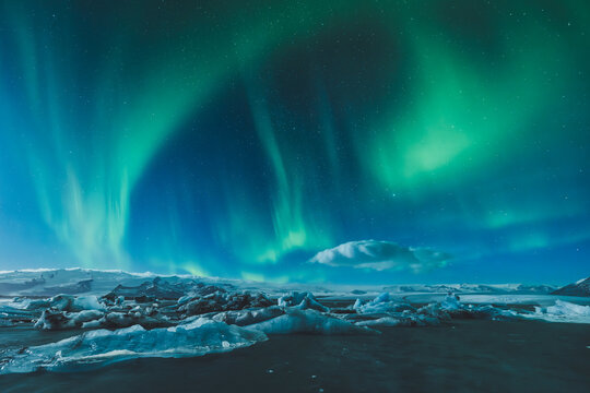 Vibrant Northern Lights Over an Icy Landscape at Night
