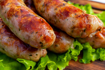 Grilled sausages served on fresh lettuce creating a hearty meal