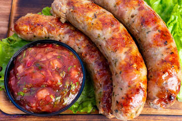 Grilled sausages served with fresh salsa on a bed of lettuce