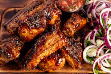Deliciously grilled ribs served with fresh salad at a summer cookout