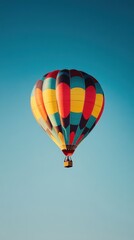 Obraz premium Colorful Hot Air Balloon Ascending In Clear Blue Sky
