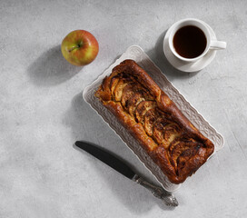 Apple Gateau Invisible and a cup of coffee on the table in hard light. top view, healthy breakfast, copy space