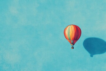 Obraz premium A Colorful Hot Air Balloon Soaring Through a Blue Sky