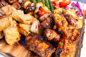 Grilled meat platter with vibrant vegetables served outdoors