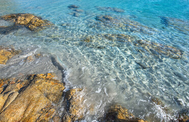 beautiful water transparent and blue of a sea in a Sardinia beach with granite rock