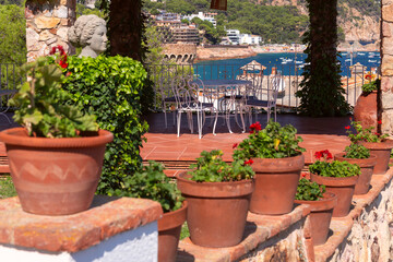 Fototapeta premium Terrace with Stone Pergola Overlooking the Sea in Tossa de Mar, Catalonia, Spain