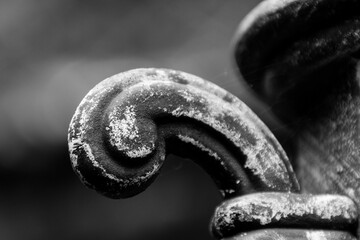 Weathered metal scroll with textured patina