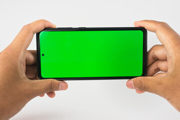 Hands Holding Smartphone with Green Screen for Technology or Display Mockup