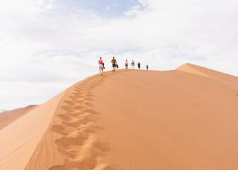 Fototapeta premium People walking on the sand dune