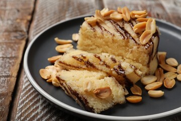 Delicious sweet semolina halva with peanuts on wooden table, closeup