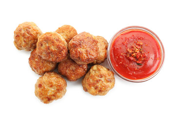 Pile of delicious meatballs and bowl with ketchup isolated on white, top view