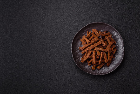 Crispy homemade brown bread crackers or croutons with seeds and grains