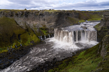 Axlafoss waterfall in Icelandic Highlands, surrounded by basalt columns