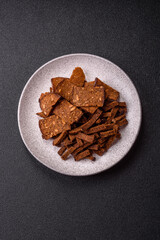 Crispy homemade brown bread crackers or croutons with seeds and grains
