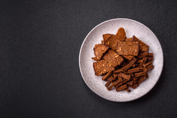 Crispy homemade brown bread crackers or croutons with seeds and grains