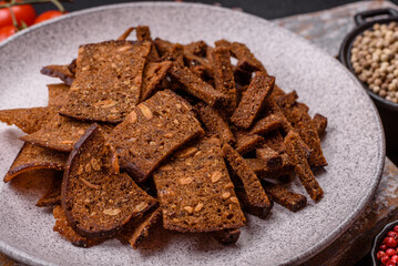 Crispy homemade brown bread crackers or croutons with seeds and grains