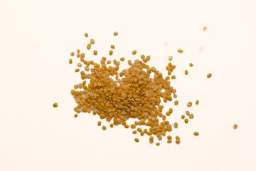 Brown seeds scattered on a light surface for natural product display