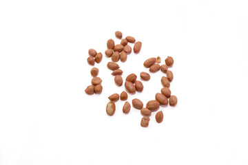 Brown peanuts scattered on white surface for display