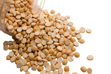 Scattered seeds spilling from a container on a plain surface