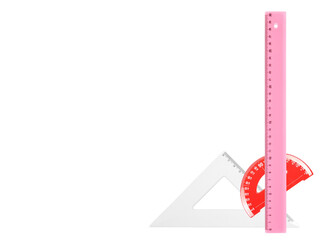 Colorful plastic triangle, ruler and semicircle, isolated on white background, top view