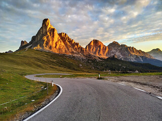 Dolomites mountains sunrise. Scenic mountain road in Dolomites, Italy