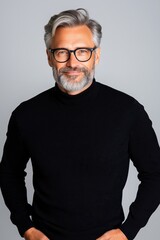 Fototapeta premium Happy man stands confidently in a studio setting on a clean background showcasing positive emotions