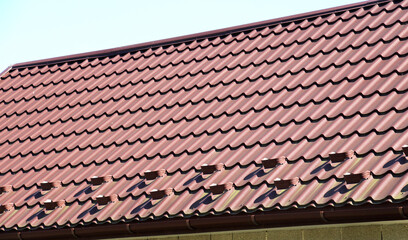 The roof of the house is covered with metal tiles