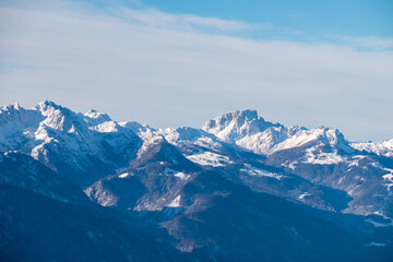 Snow-capped peaks of majestic Carnic Alps seen from mountain peak Tscheckelnock, Carinthia, Austria. Dramatic mountainous range. Winter wonderland landscape. Wilderness, Austrian Alps. Clear blue sky
