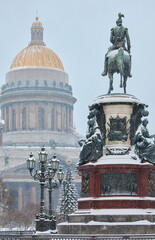 a snow-covered New Year's city decorated for the celebration of the new year, the golden dome of...