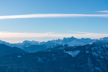 Fototapeta premium Snow-capped peaks of majestic Julian Alps seen from mountain peak Tscheckelnock, Carinthia, Austria. Dramatic mountainous range. Winter wonderland landscape. Wilderness, Austrian Alps. Clear blue sky