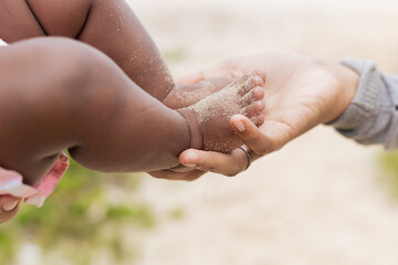 Happy baby girl on her first time at the beach playing. Rio de Janeiro, Brazil.