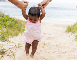 Happy baby girl on her first time at the beach playing. Rio de Janeiro, Brazil.