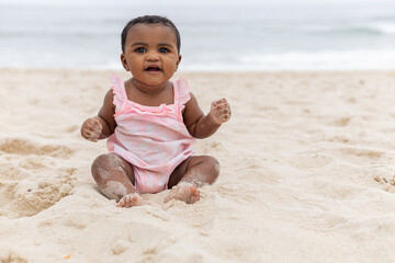 Happy baby girl on her first time at the beach playing. Rio de Janeiro, Brazil.