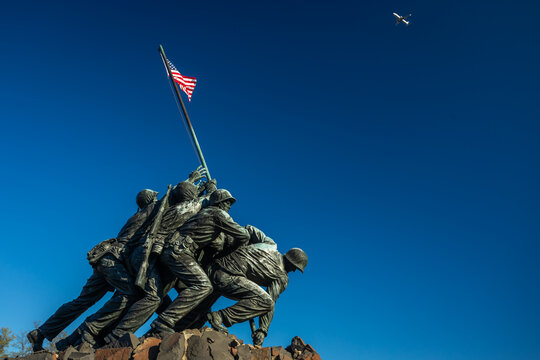 20 November 2022 - Arlington, VA, USA: US Marine Corps War Memorial Iwo Jima on a sunny Day with blue Sky and Aircraft; plenty Copyspace