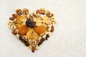 Concept of the Jewish holiday Tu Bishvat. Heart-shaped arrangement of dried fruits and nuts