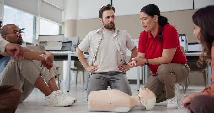 First aid, training and mannequin with people in cpr workshop for learning, healthcare and demonstration. Paramedic course, instructor and teaching with person in class for emergency and rescue