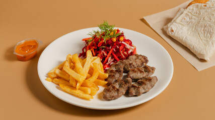 Cevapcici and fries on plate