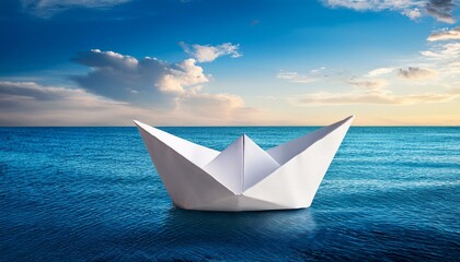 Obraz premium white paper boat floating in blue sea