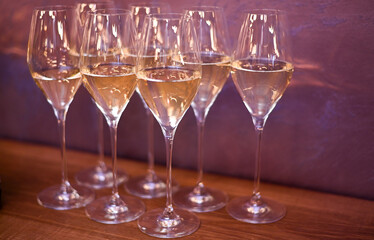 glasses of white wine on the table.