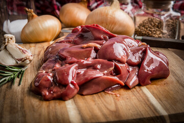 Raw chicken liver on cutting board.
