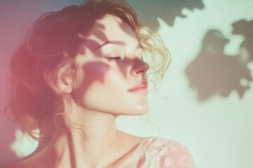 Fototapeta premium Woman with curly hair enjoying sunlight and shadows from leaves in a serene moment