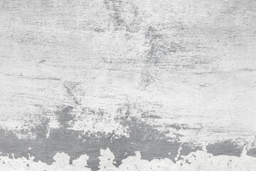 Grungy gray concrete wall with brush strokes of white paint