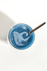 Blue matcha in glass cup. Vertical