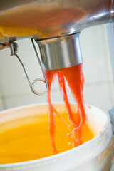 manufacture of tomato sauce, sauce out of the machine for potting.