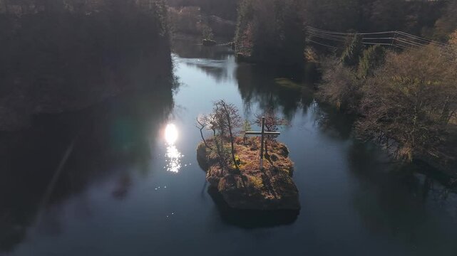 Drone footage of the Cross of the Traun on a small islet on Traun River in Austria, on a sunny day