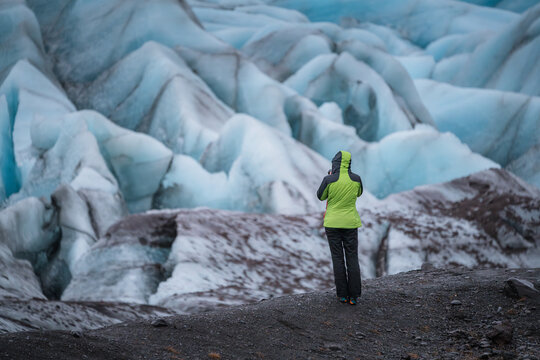 Solo Adventurer Capturing the Breathtaking Glacial Landscape in a Remote, Frozen Wilderness