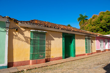 Historic residential buildings on Calle Real del Jigue near Plaza Mayor in historic city centre of Trinidad, Cuba. Historic Trinidad Centre is a World Heritage Site. 