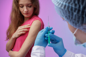 Vaccination process: woman receiving vaccine in modern clinic, close-up